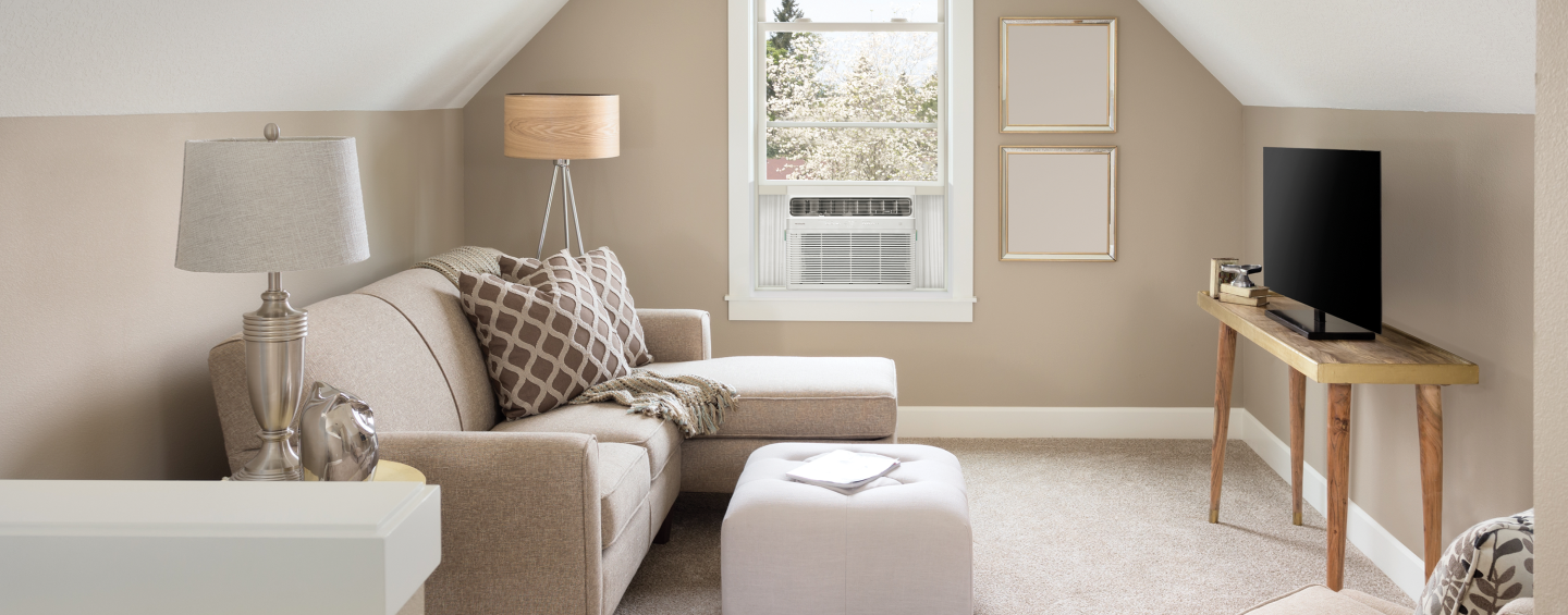 Attic living room with a window air conditioner unit 